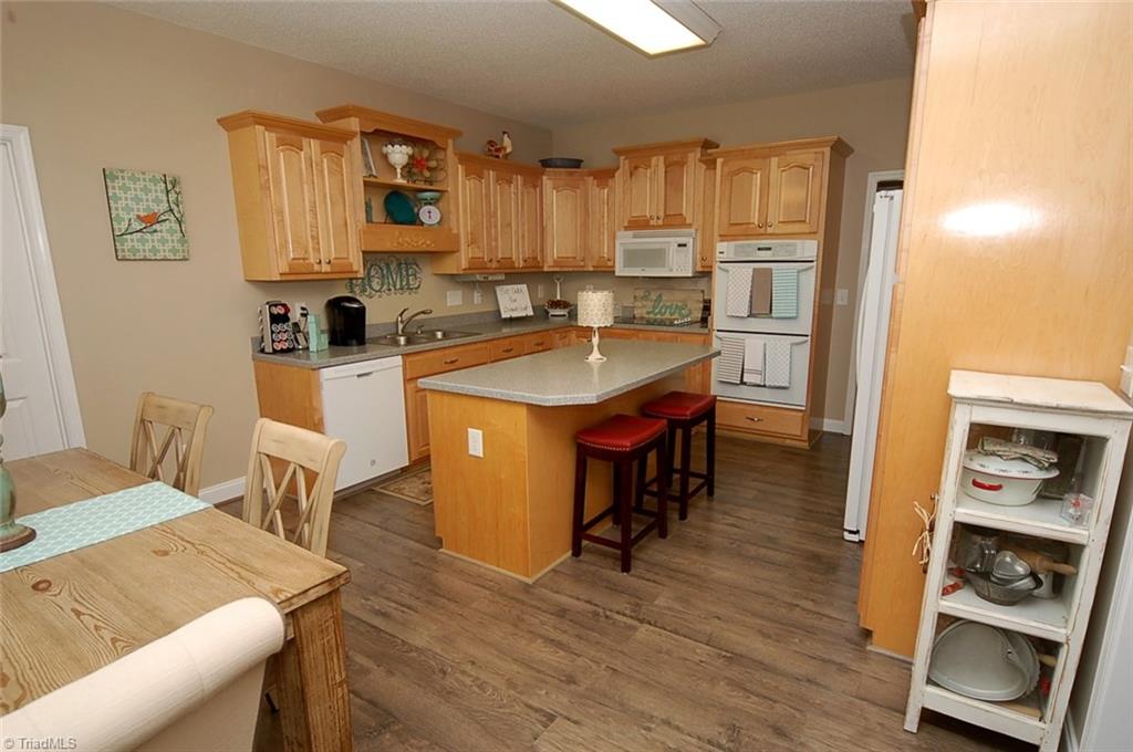 A view of the kitchen from the entry. Wonderful cabinet space and a double oven make cooking in here a pleasure!