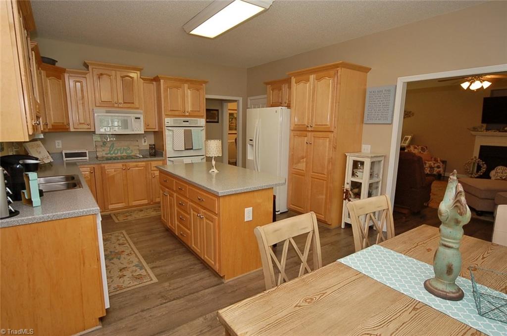 6205 Monnett Road Julian, NC 27283 - Photo 8 of 30 The kitchen island offers additional seating as well as extra counter space.