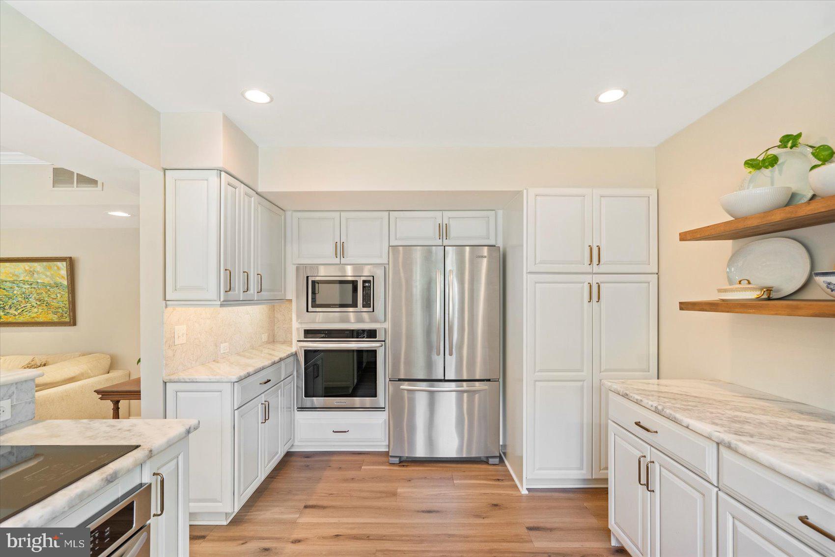 2413 Stanwick Road Phoenix, MD 21131 - Photo 24 of 46 a kitchen with stainless steel appliances granite countertop a refrigerator and a stove top oven