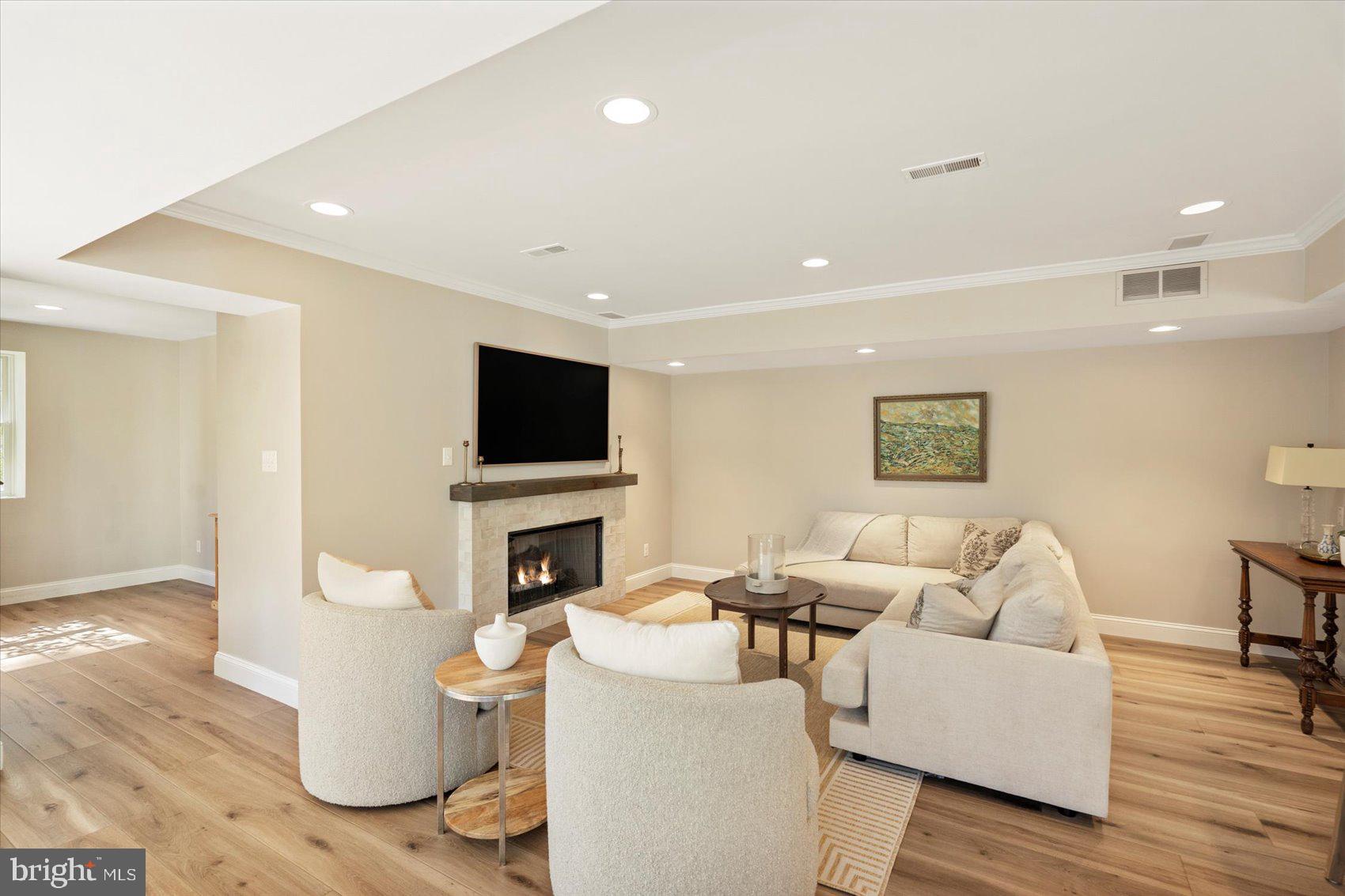 2413 Stanwick Road Phoenix, MD 21131 - Photo 25 of 46 a living room with furniture a flat screen tv and a fireplace