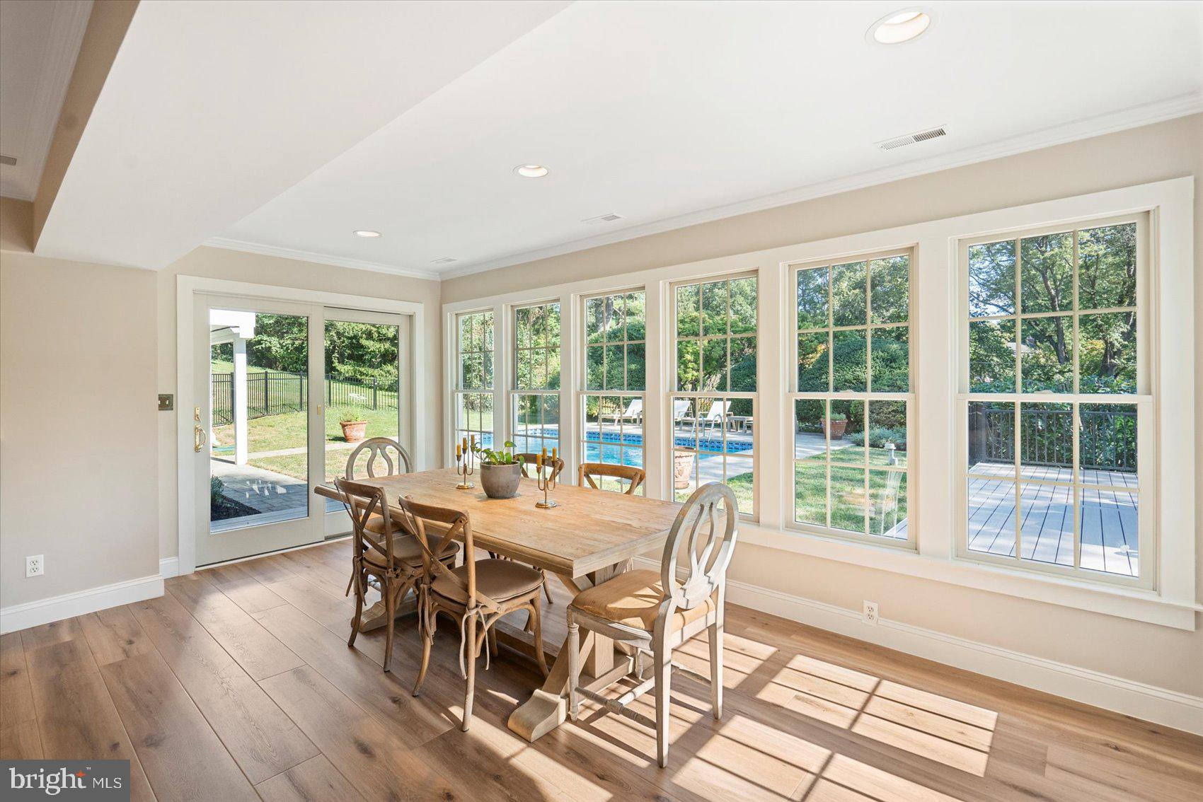 2413 Stanwick Road Phoenix, MD 21131 - Photo 26 of 46 a view of a dining room with furniture large windows and wooden floor