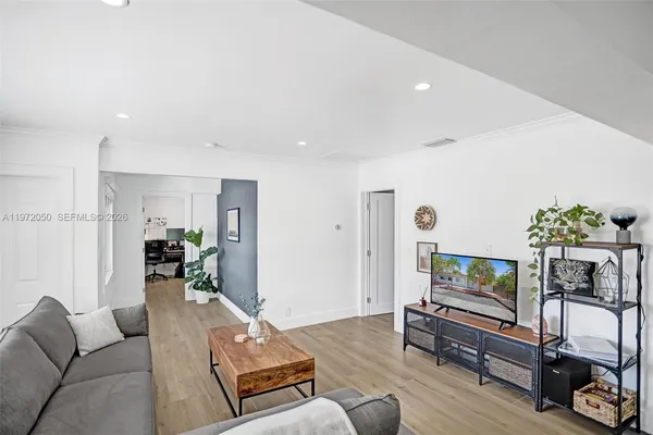 a living room with furniture and a flat screen tv