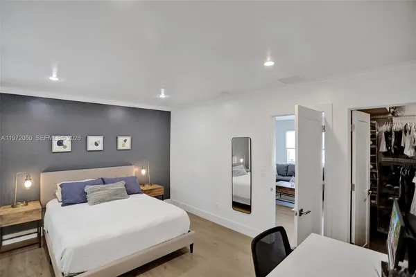 a bedroom with a bed and walk in closet