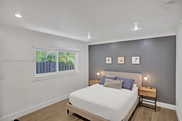 a bedroom with a bed and a window