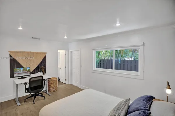 a bedroom with a workspace