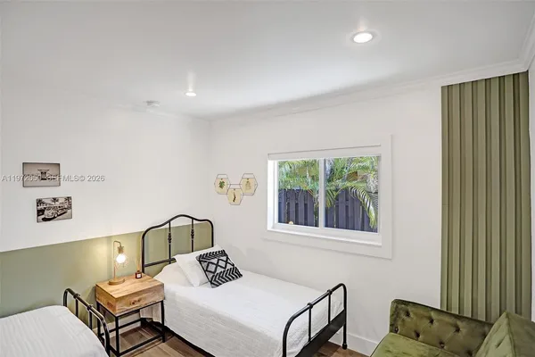 a bedroom with furniture and a window