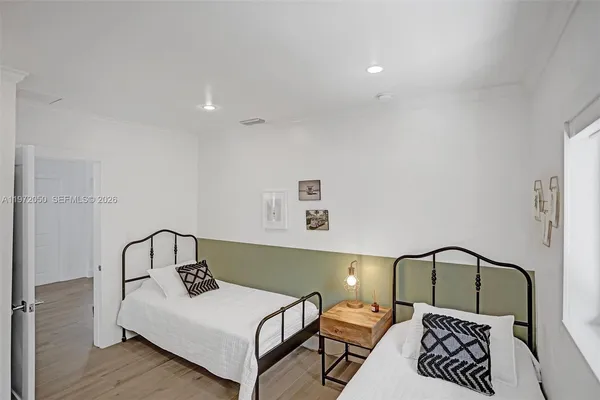 a bedroom with a bed and a black white bedspread