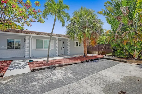 a backyard of a house with table and chairs