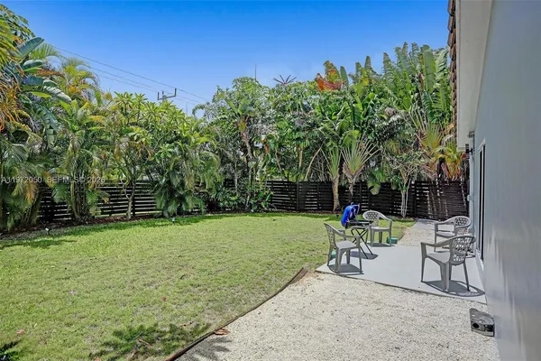 a view of a backyard with sitting area