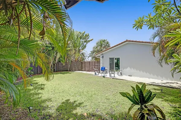 a house with palm tree in front of it