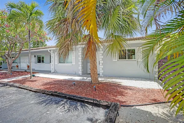a house with palm tree in front of it