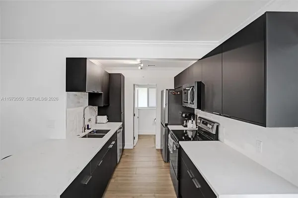 a kitchen with stainless steel appliances a refrigerator stove and oven