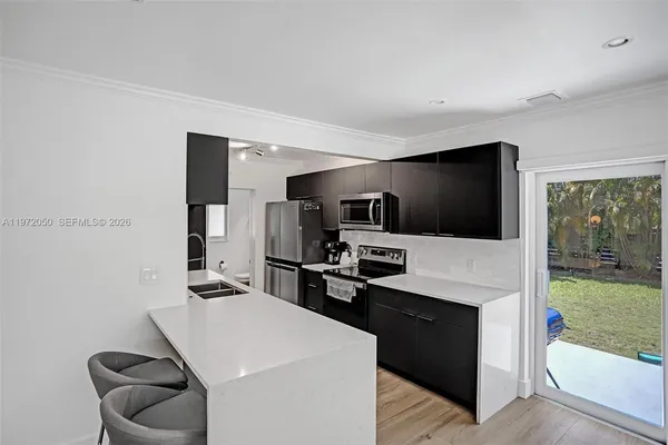 a kitchen with white cabinets and stainless steel appliances
