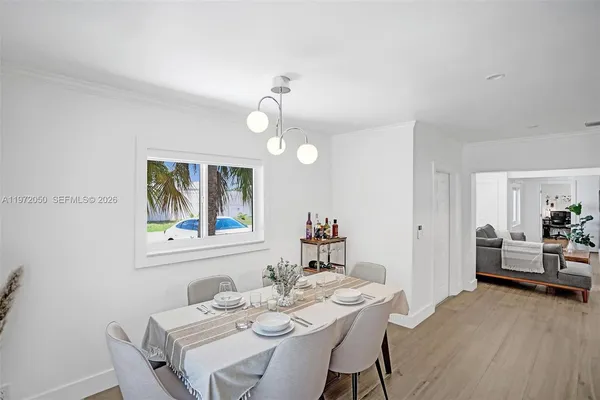 a view of a dining room with furniture wooden floor and a chandelier