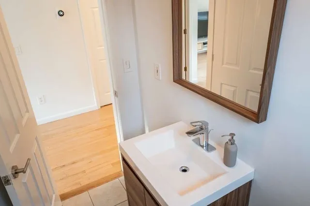 a spacious bedroom with a bed and a lamp