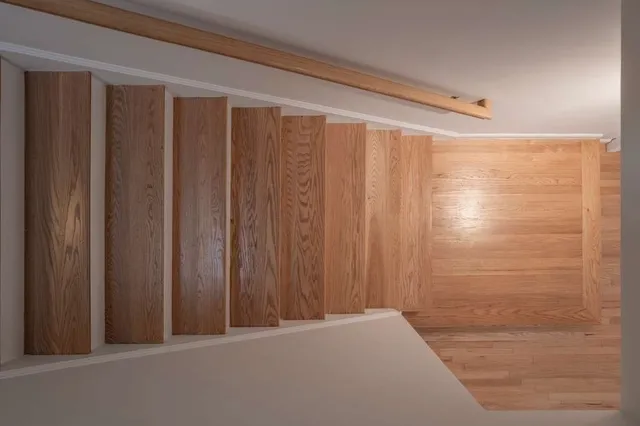 a view of a house with wooden fence