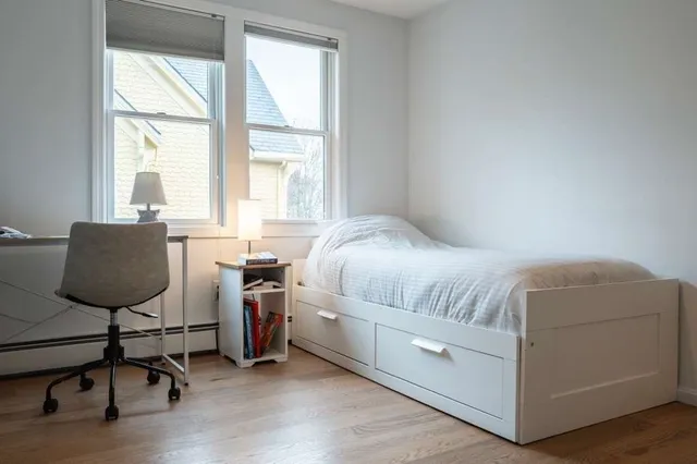 a bedroom with a bed and a lamp