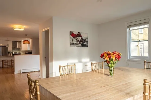 a view of a dining room with furniture and a window