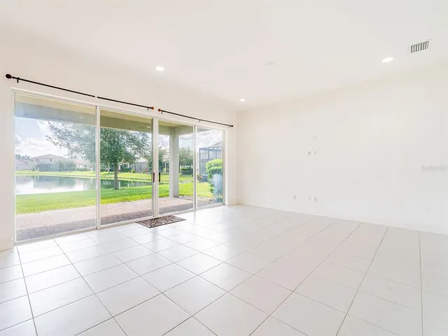 a view of an empty room with a floor to ceiling window