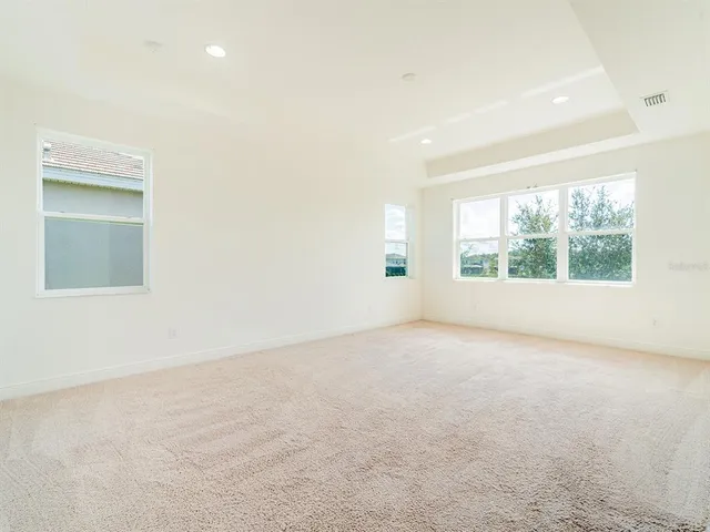 an empty room with windows and closet
