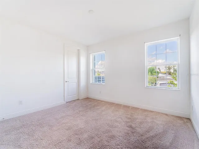a bathroom with a granite countertop sink a toilet a mirror a bathtub and shower