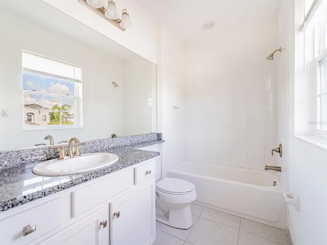 a front view of a house with a garden and yard