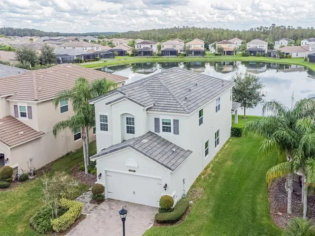 an aerial view of residential house with outdoor space and lake view