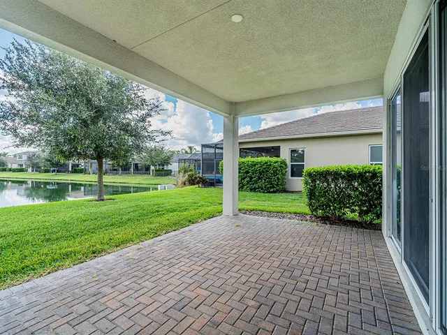 an aerial view of multiple houses with a yard