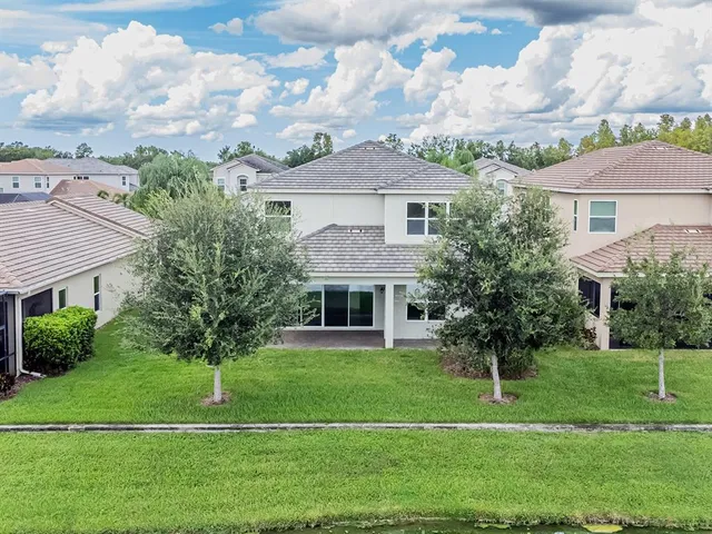 an aerial view of a house with a garden and a yard