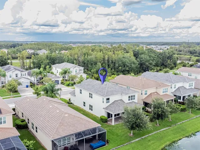 an aerial view of a house swimming pool and outdoor seating