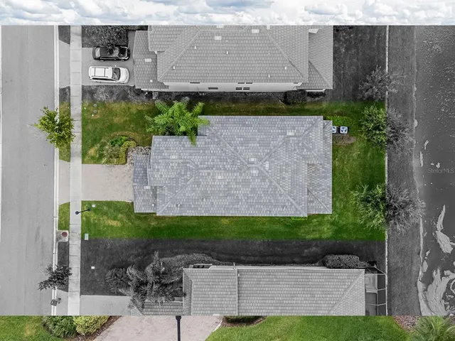 an aerial view of residential houses with outdoor space