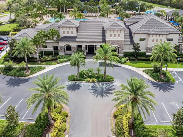 an aerial view of residential houses with outdoor space and swimming pool