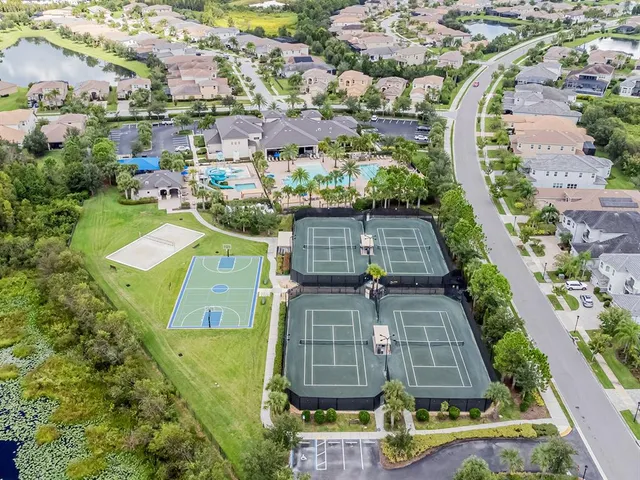 a living room with pool table and windows