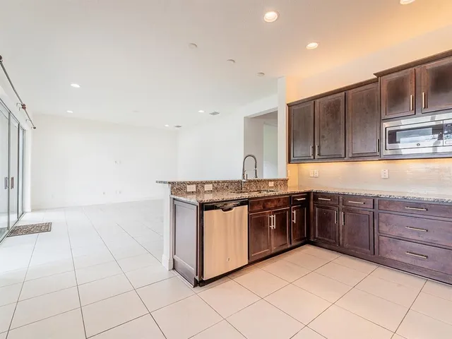 a kitchen with stainless steel appliances granite countertop a stove and a sink