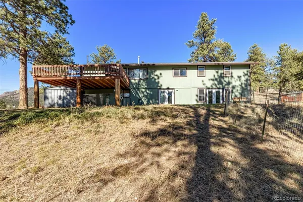 a kitchen with stainless steel appliances granite countertop a refrigerator a stove and a sink with wooden floor