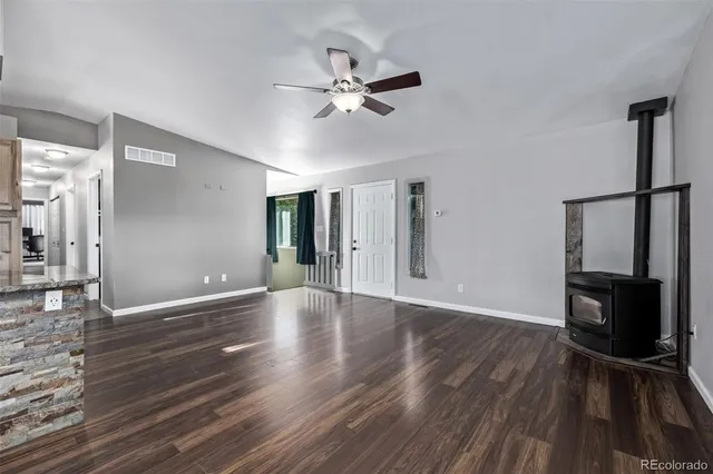 a open kitchen with cabinets wooden floor and stainless steel appliances
