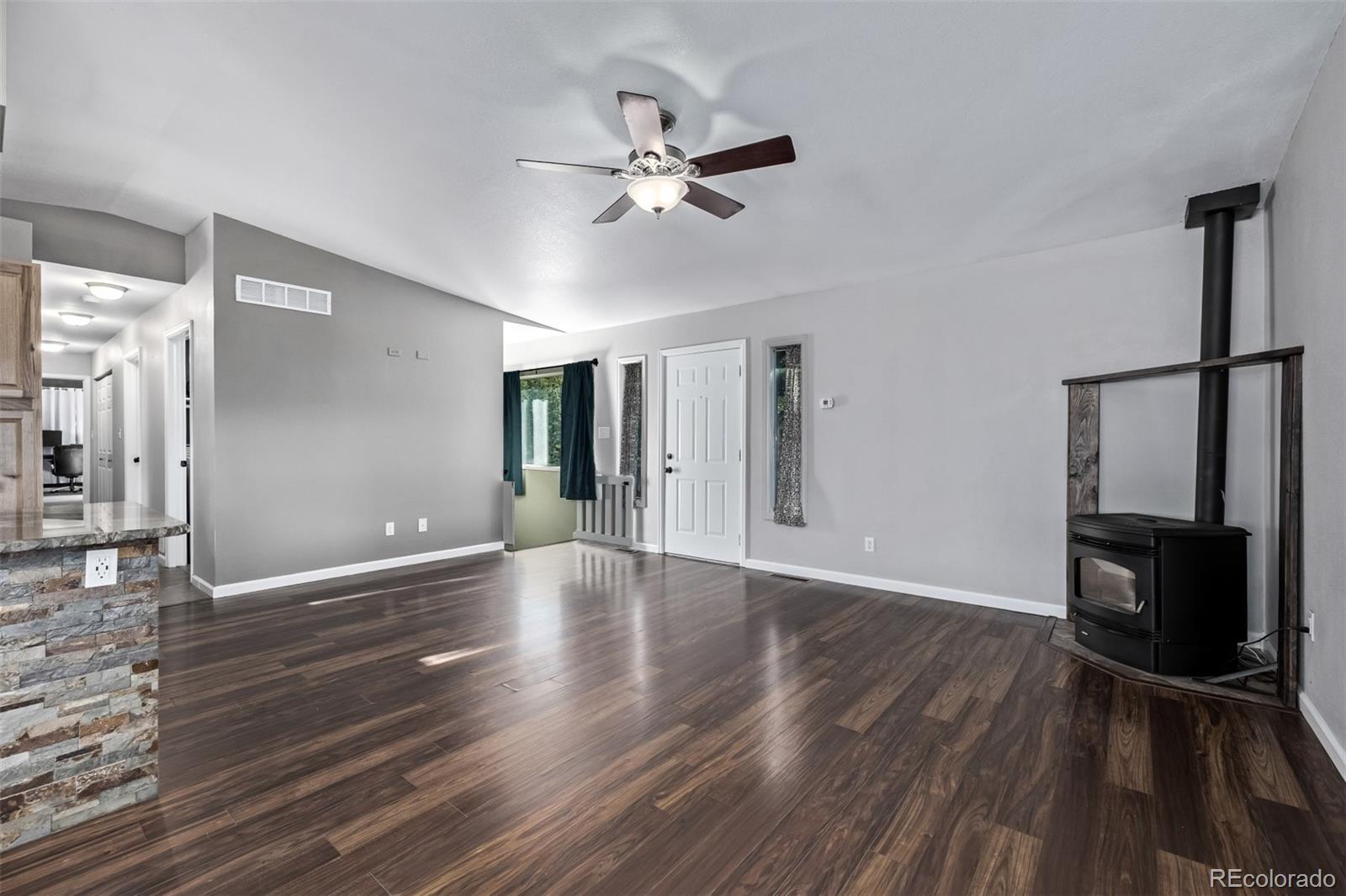 20 Parkview Bailey, CO 80421 - Photo 15 of 50 a view of an empty room with wooden floor and a ceiling fan
