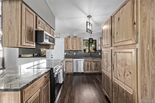 a kitchen with stainless steel appliances a refrigerator sink and cabinets