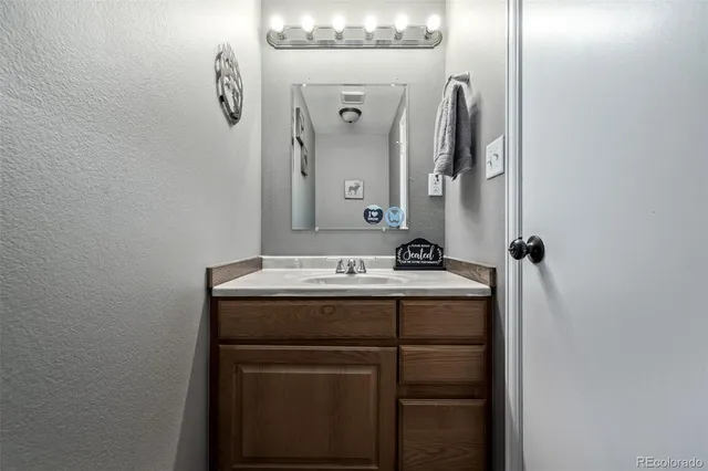 a bathroom with a sink toilet and mirror