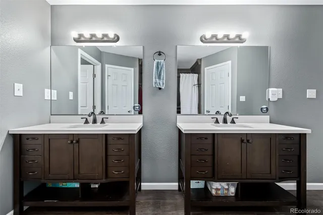 a view of a livingroom with wooden floor and furniture
