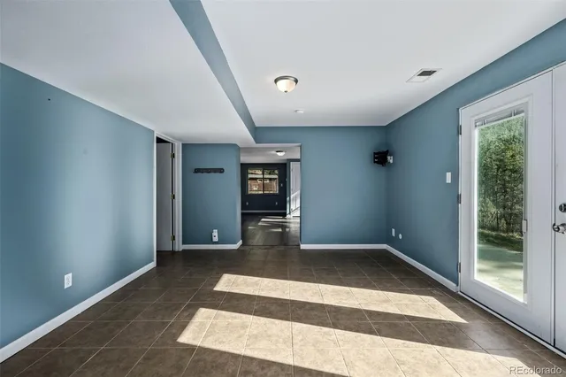 a view of a livingroom with wooden floor and a ceiling fan