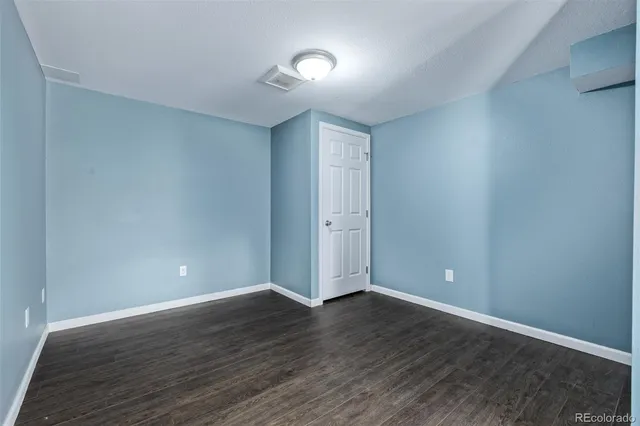 a view of a patio with a table and chairs under an umbrella with wooden fence