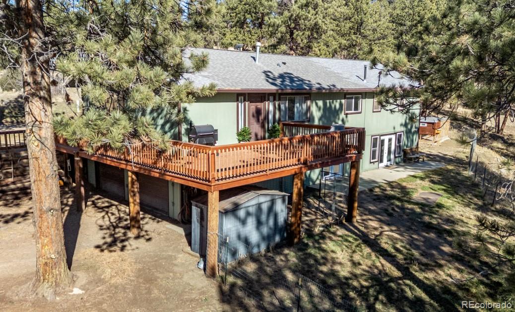 20 Parkview Bailey, CO 80421 - Photo 38 of 50 a view of a patio with a table and chairs under an umbrella with wooden fence
