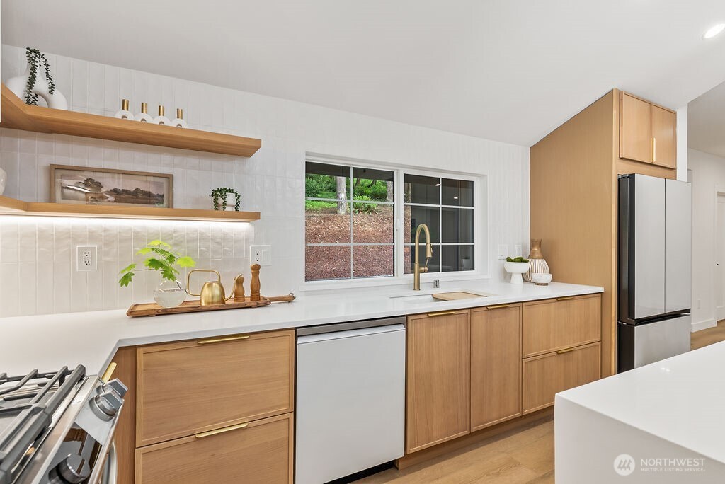 19433 Southeast 128th Street Renton, WA 98059 - Photo 19 of 40 a kitchen with a refrigerator and a sink