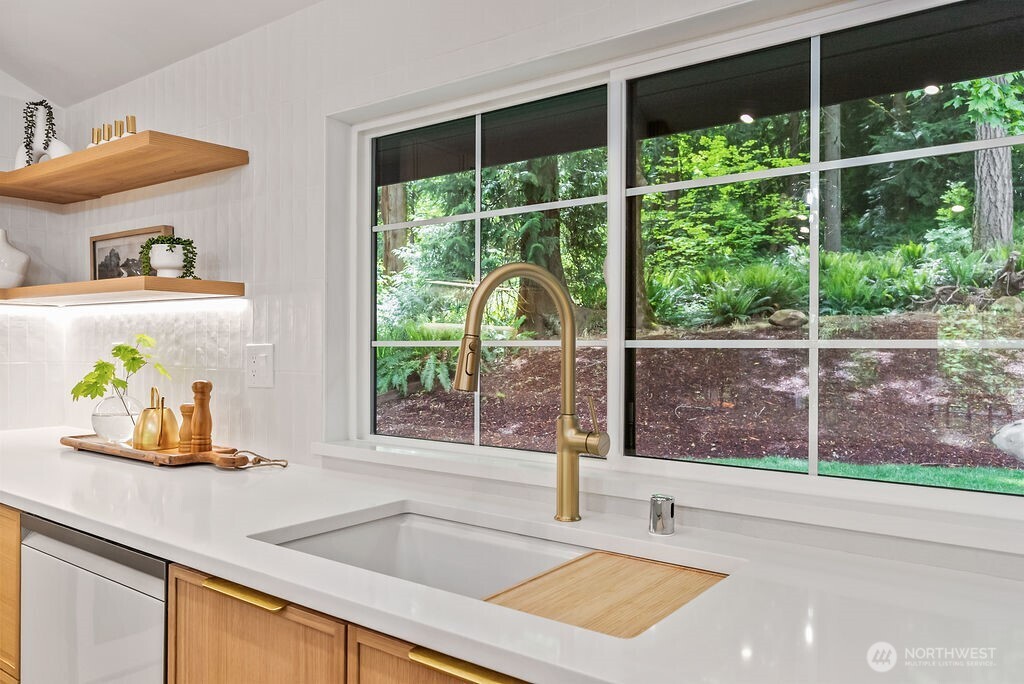 19433 Southeast 128th Street Renton, WA 98059 - Photo 20 of 40 a kitchen with a sink a counter and a large window