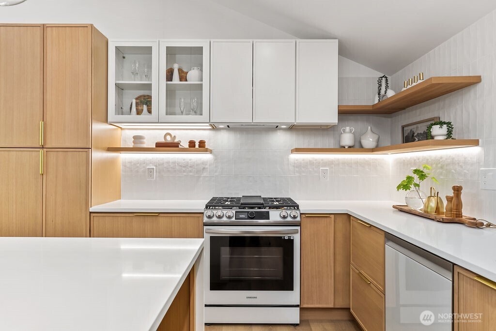 19433 Southeast 128th Street Renton, WA 98059 - Photo 21 of 40 a kitchen with stainless steel appliances a stove and a refrigerator
