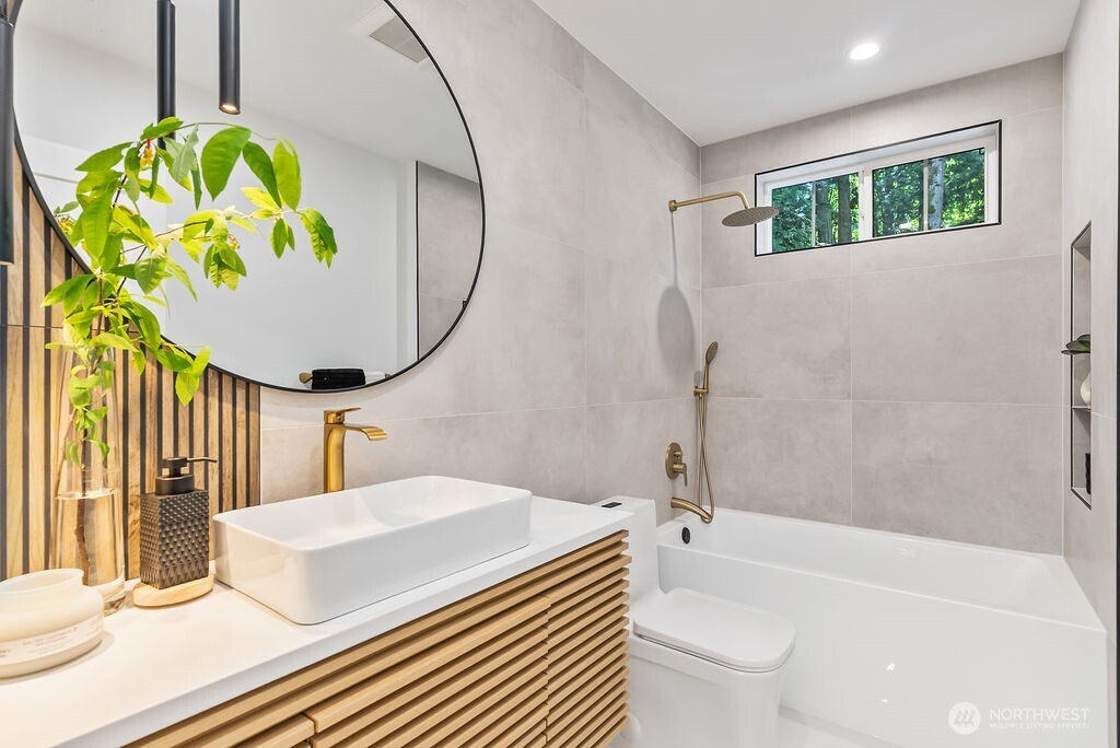 19433 Southeast 128th Street Renton, WA 98059 - Photo 25 of 40 a bathroom with a sink a toilet and a bathtub