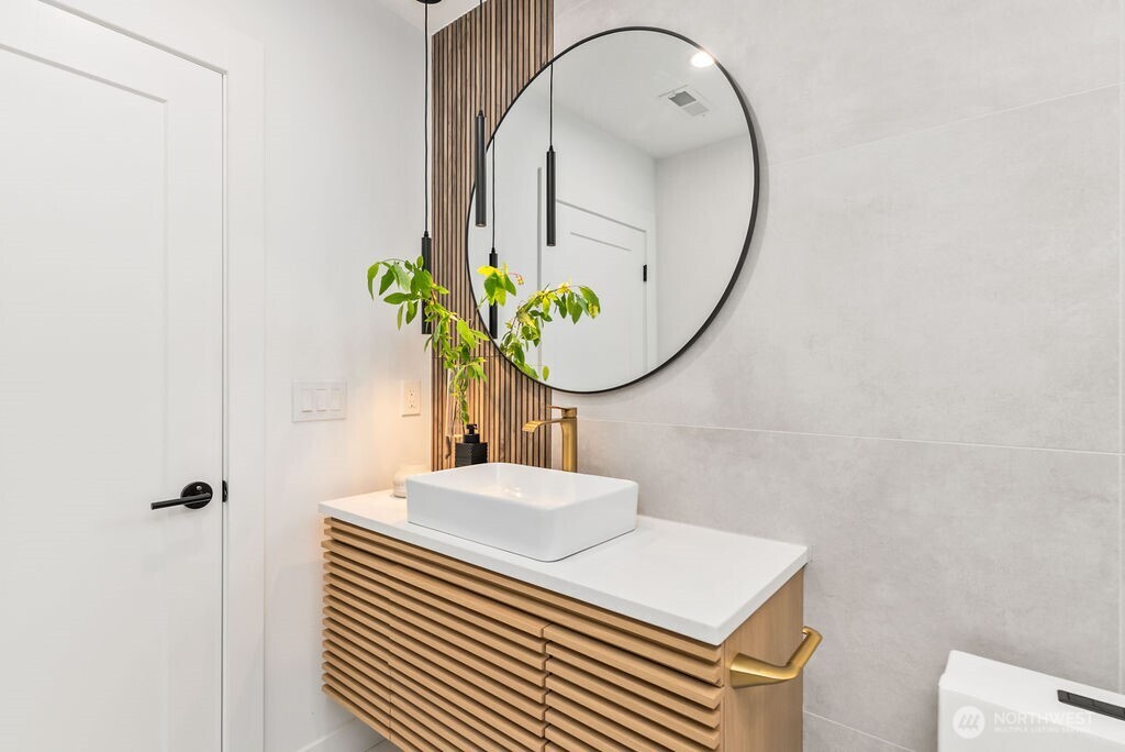 19433 Southeast 128th Street Renton, WA 98059 - Photo 26 of 40 a bathroom with a sink a potted plant and a mirror