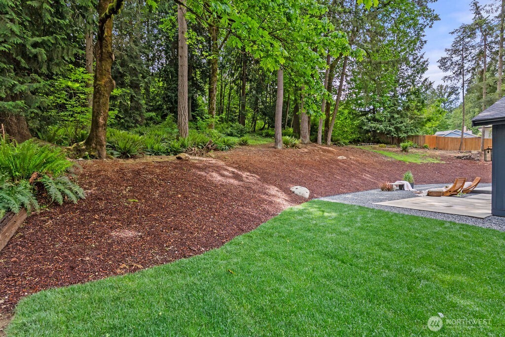 19433 Southeast 128th Street Renton, WA 98059 - Photo 37 of 40 a view of a backyard with table and chairs and wooden fence