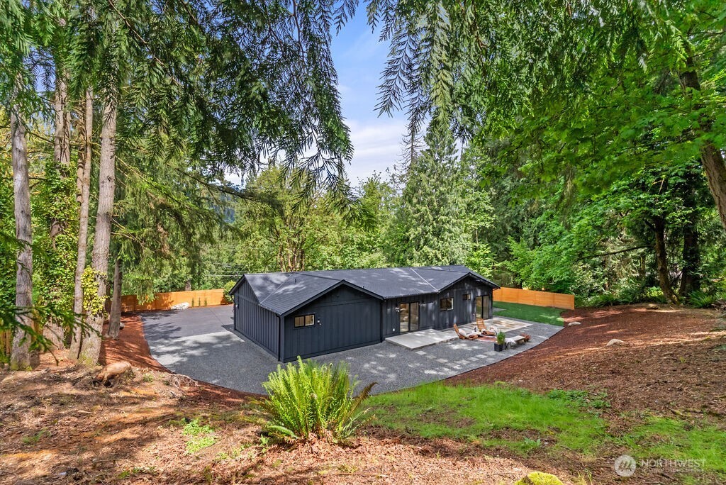 19433 Southeast 128th Street Renton, WA 98059 - Photo 39 of 40 a wooden bench sitting in the middle of a garden